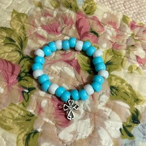 Blue and white plastic beads with silver cross charm